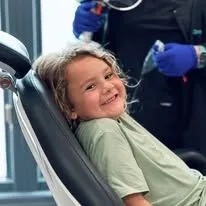 Child smiling in dental chair