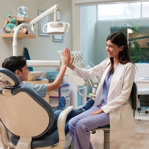 Child giving the dentist a high five